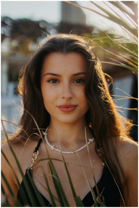 Portrait of a young woman enjoying the sunny outdo