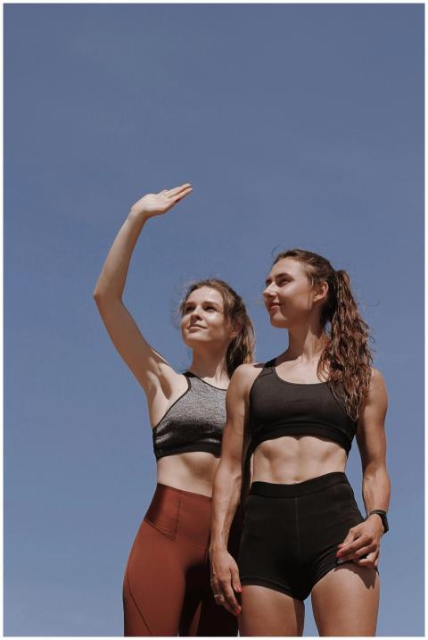 Two women in activewear showcasing fitness and str