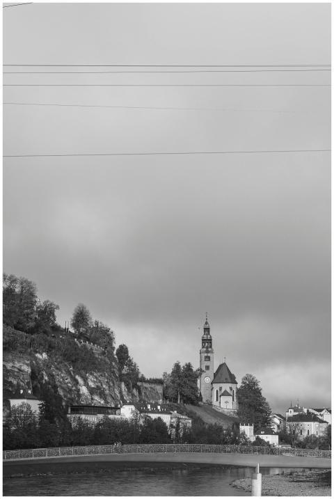 Black and white view of a church tower and bridge