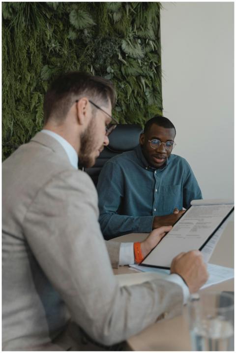Two men in a modern office setting discussing a do