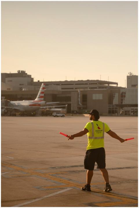 Airport Worker Directing Plane