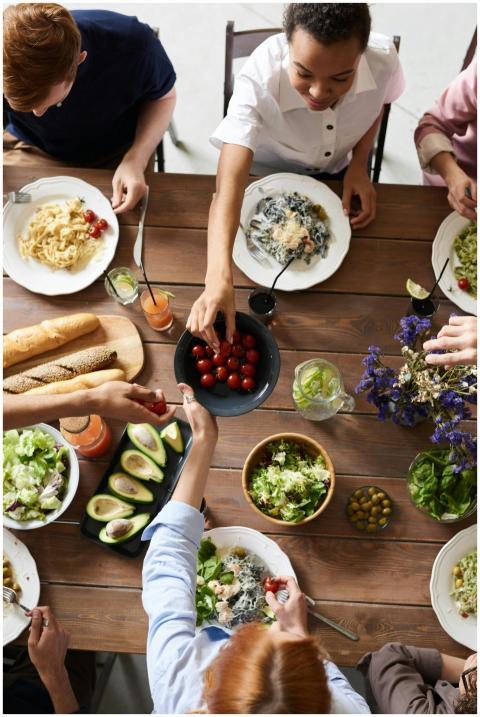 A group of people sharing a vibrant meal with sala
