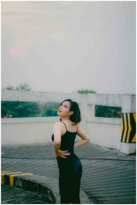 A woman posing in an urban landscape as the sun se