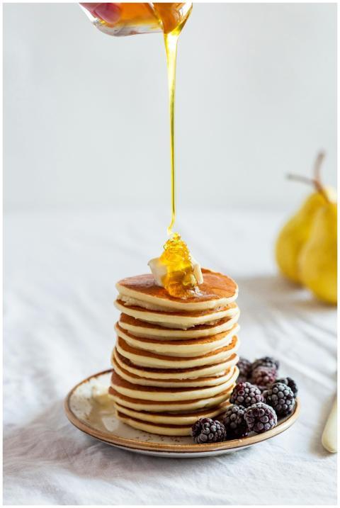 Mouthwatering stack of pancakes drizzled with hone
