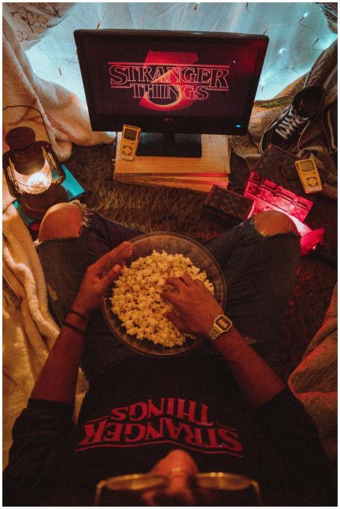 Person enjoying popcorn while watching Stranger Th