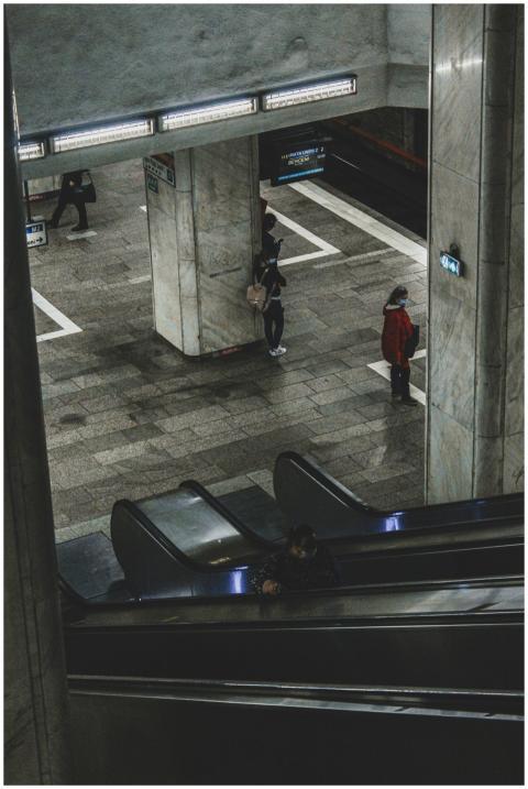 High-angle view of people on escalators in a subwa