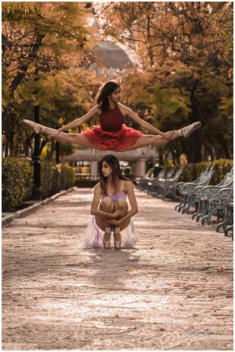 Two female ballet dancers performing in a vibrant