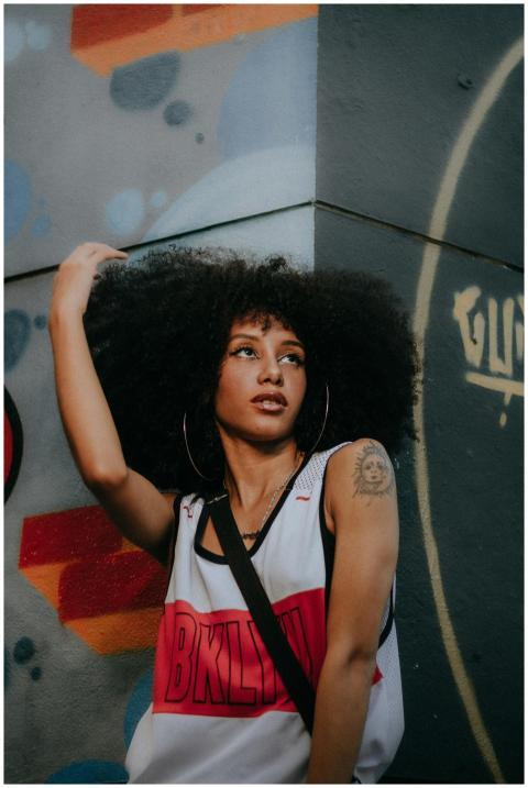 Stylish urban portrait of a young woman with an af