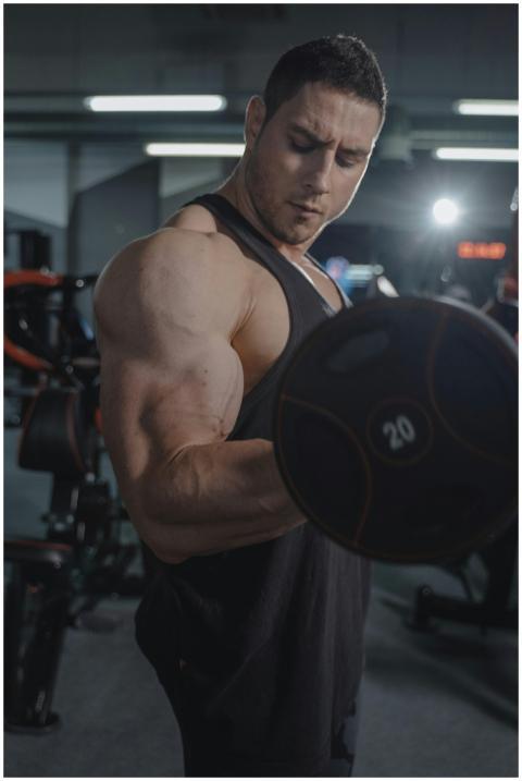 A strong, fit man working out indoors, focusing on