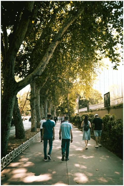 Tourists strolling along a shaded walkway in Istan