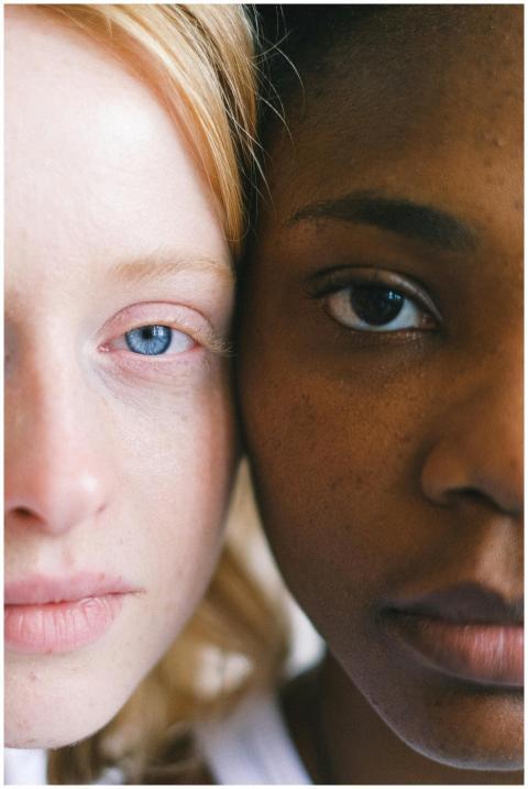 Intimate close-up of two women of different ethnic