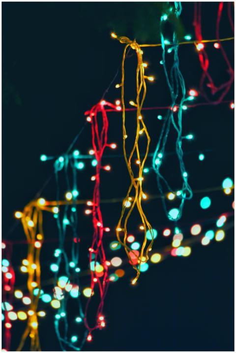 Vibrant string lights hanging outdoors create a fe