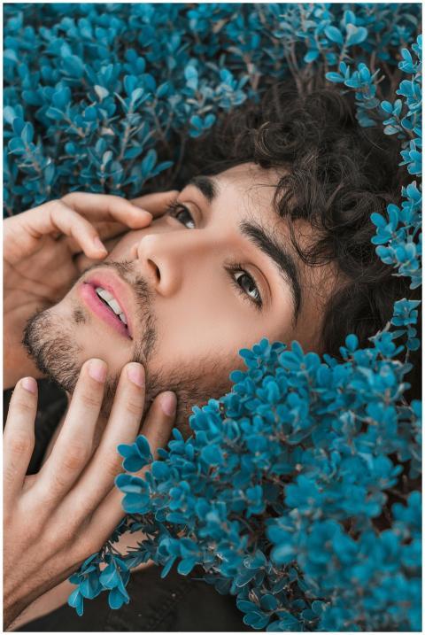 Close-up portrait of a man surrounded by vibrant b