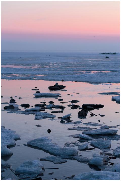 Tranquil scene of a frozen seashore with icy forma