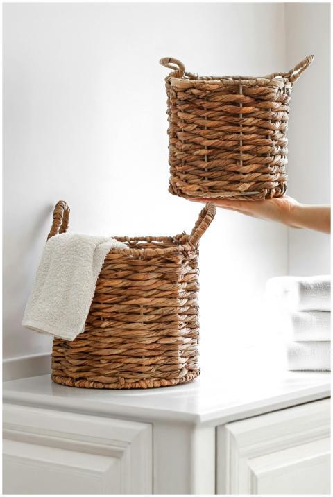 Stylish wicker baskets with towels in a bright, mo