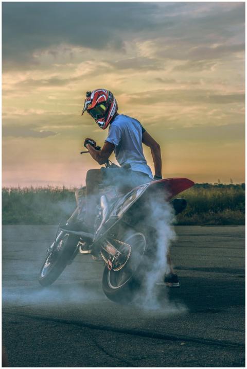 Motorcyclist performing a drift on pavement, creat