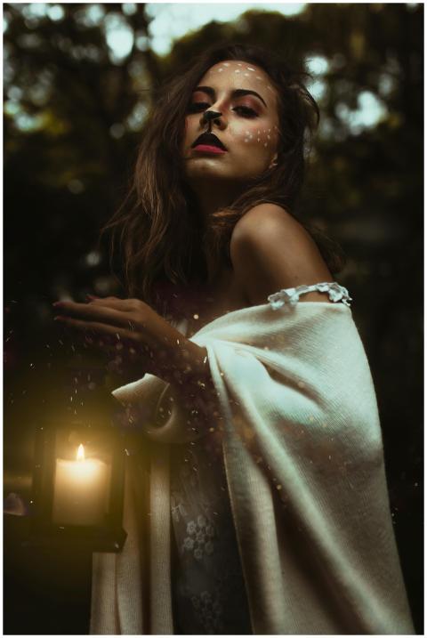 A captivating woman with face paint and lantern po