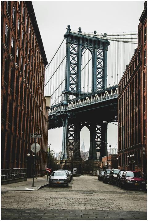 View of Manhattan Bridge between red brick buildin