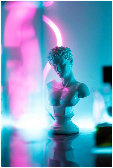 Classical bust statue with neon pink and blue ligh