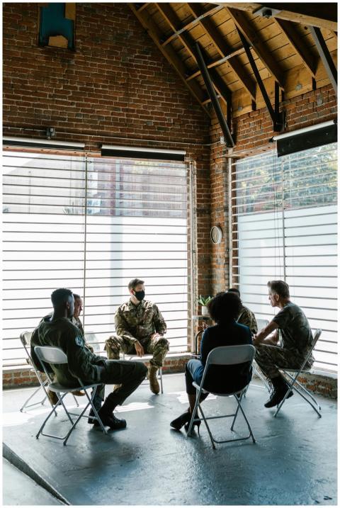 Soldiers in a group therapy session discussing men