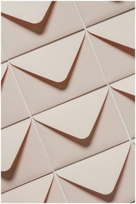 Artistic arrangement of beige envelopes creating a