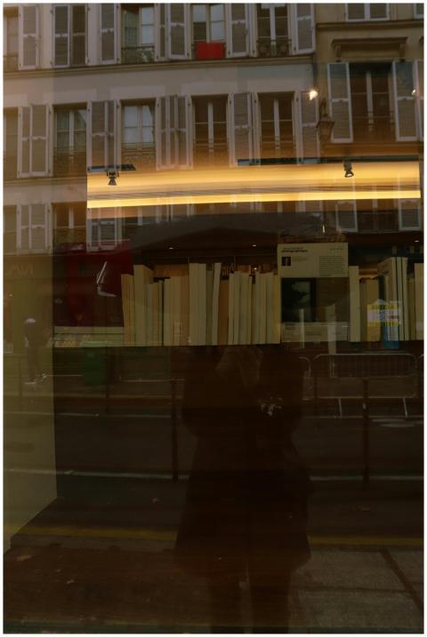 Reflection of a Parisian street and bookshop windo