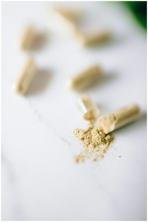 Close-up view of open capsules spilling powder on