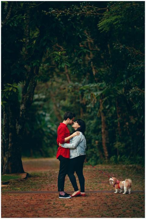 Young couple embracing in a lush forest with their