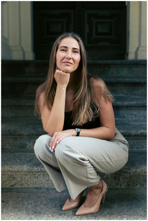 Portrait of a confident woman sitting on historica