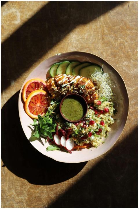 Colorful salad bowl with fresh veggies and dressin