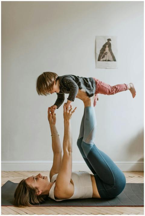 A mother and daughter bonding through acro yoga at