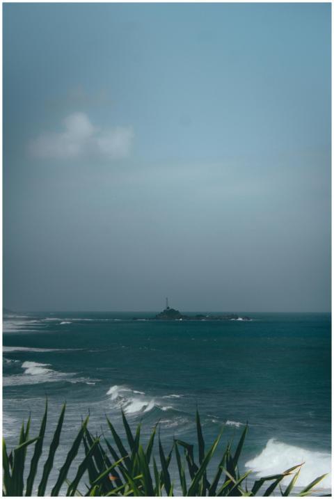 Peaceful ocean view featuring a distant lighthouse