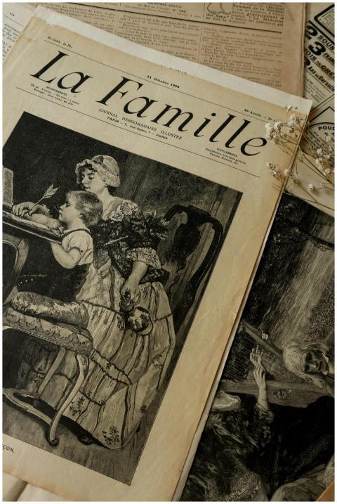 Artistic shot of vintage newspaper 'La Famille' wi