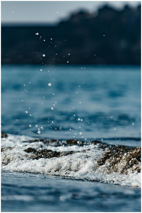 Close-up of ocean waves splashing under the bright