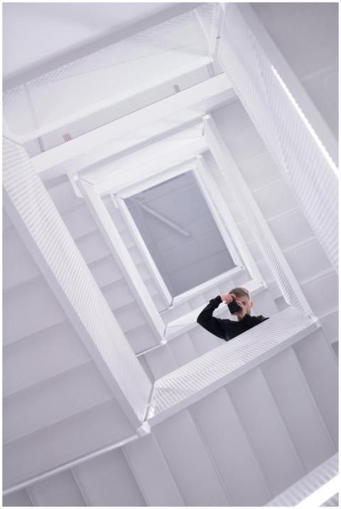 Dramatic upward view of a person on a spiral stair