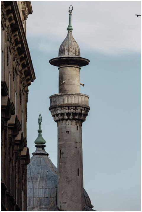 Close-up view of an ornate mosque minaret with cle