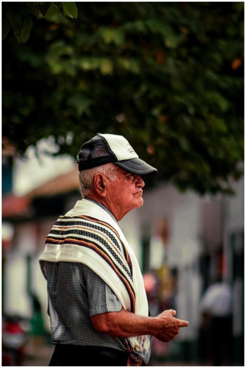 Portrait of an elderly man wearing a cap and tradi
