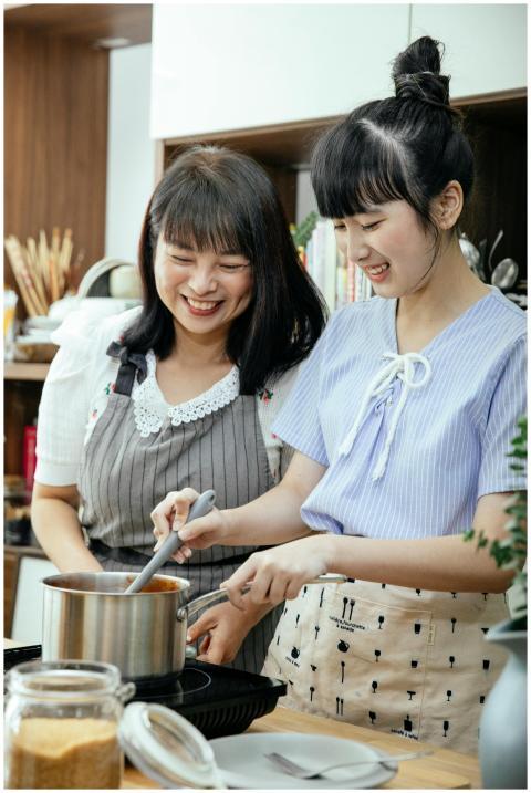 Asian mother and daughter enjoying a cooking sessi