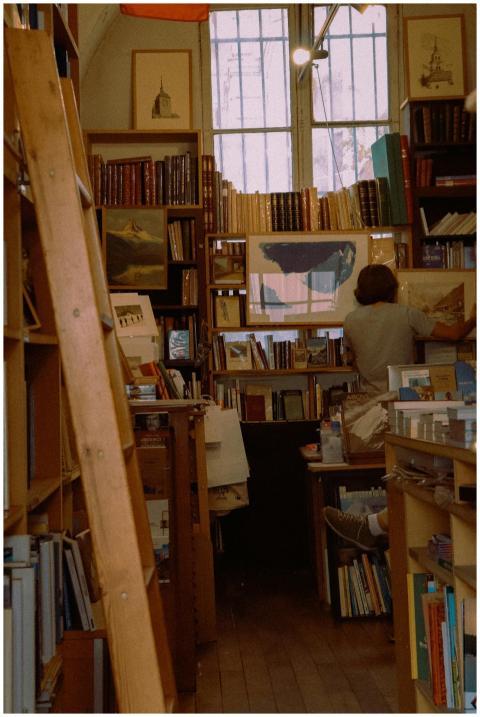 A cozy Parisian bookstore with wooden shelves fill