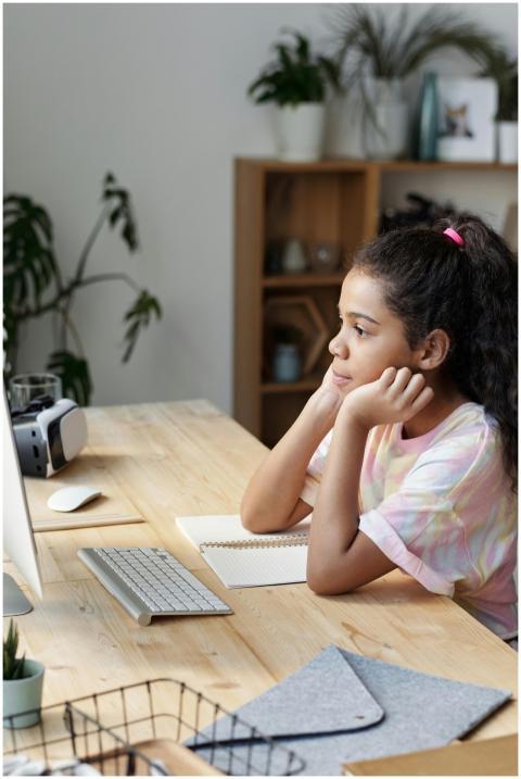 Girl studying online at home, concentrating on com
