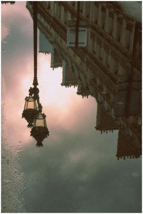 Artistic reflection of Parisian street lamps and a