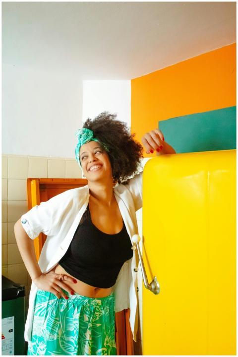 Delighted woman posing in a vibrant kitchen with c