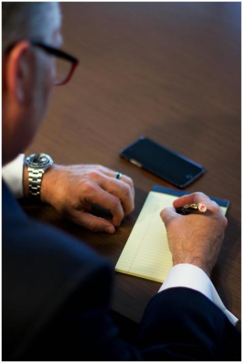 Close-up of a businessman writing notes in an offi