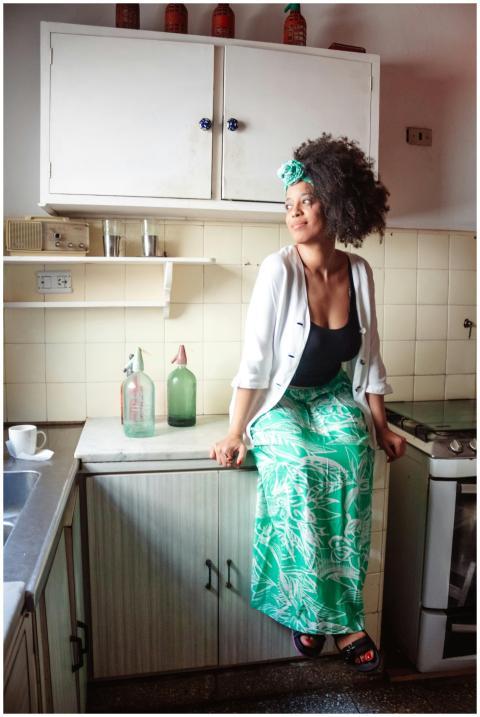 A woman sits on a kitchen counter, exuding a relax