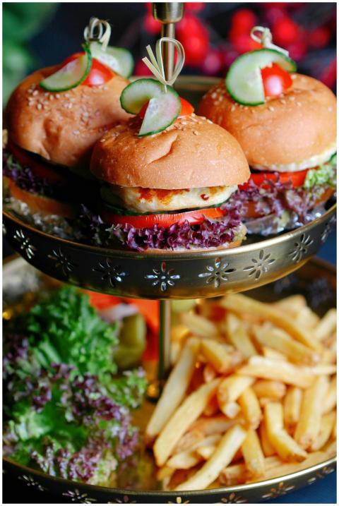 Delicious gourmet burgers with fries on an ornate