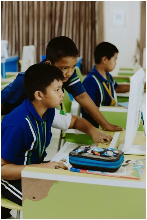 Group of children using computers in a bright, mod