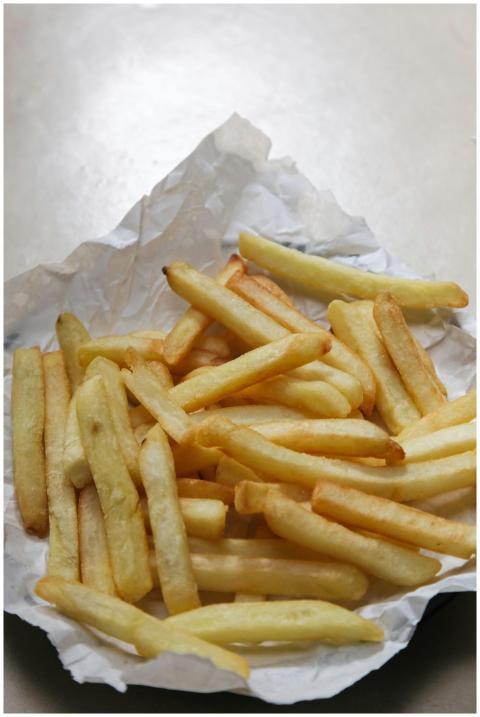A close-up of crispy, golden French fries served o