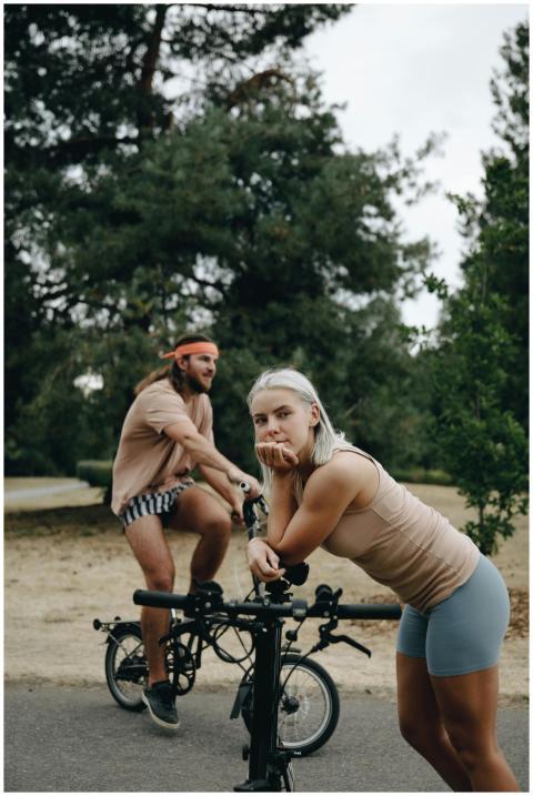 Two young adults on bicycles, enjoying a leisurely