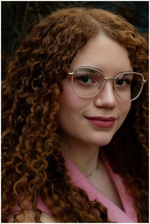 Close-up portrait of a woman with red curly hair a