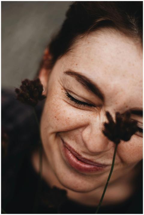 Close-up portrait of a smiling young woman with fr